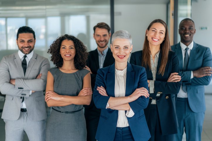 Contact us Portrait of multi ethnic business team looking at camera in the office